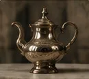 A silver teapot.